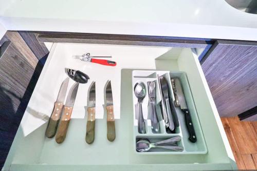 a tray with silver utensils on a table at HOM I Conjunto frente a la Costanera 2D2B in Puerto Varas