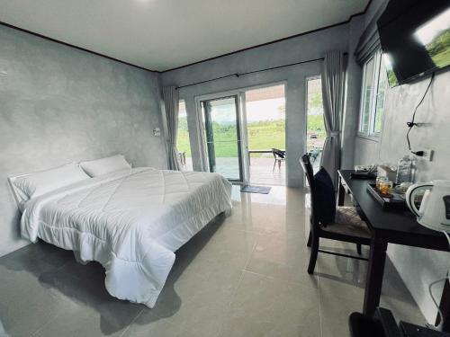 Postel nebo postele na pokoji v ubytování Himmuang Homestay
