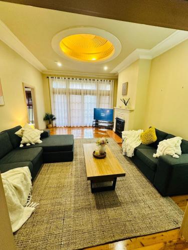 a living room with two couches and a coffee table at Tamworth suite - Your Boutique Retreat in Dubbo in Dubbo