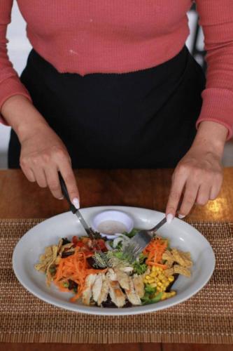 a person eating a plate of food on a table at NEIZAN HOTEL in Antigua Guatemala