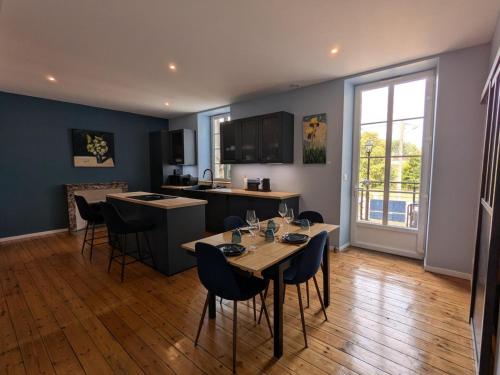 a kitchen and dining room with a table and chairs at Maison Ivaldi - FR-1-653-280 in Jarnac