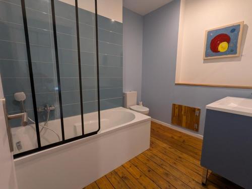 a bathroom with a bath tub and a toilet at Maison Ivaldi - FR-1-653-280 in Jarnac