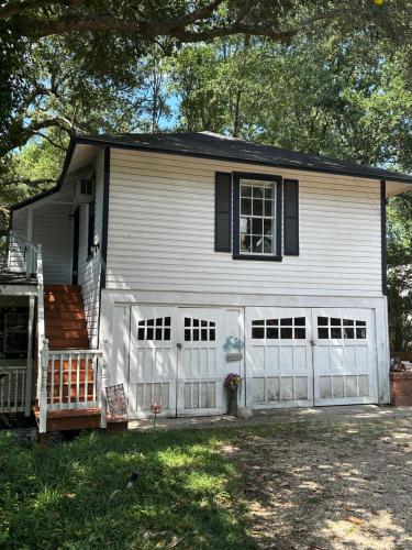 a white house with a white garage at Cici's Guest House in Laurel