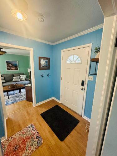 a living room with blue walls and a white door at Cici's Guest House in Laurel