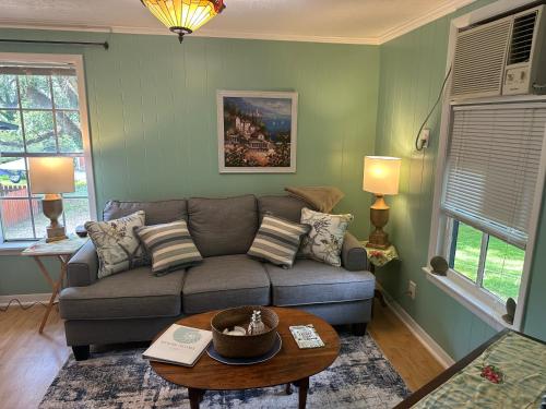a living room with a couch and a table at Cici's Guest House in Laurel