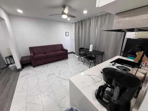 a living room with a couch and a table at Modern Guesthouse W Parking 12Min to Strip in Las Vegas