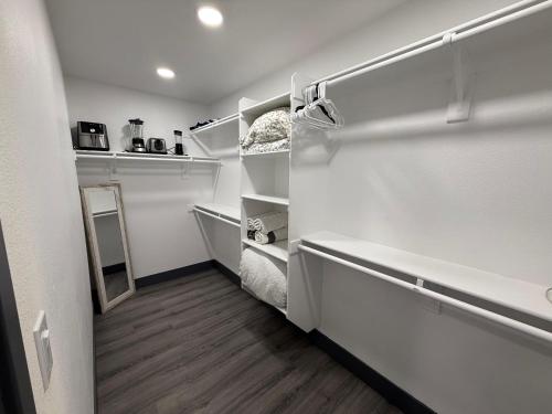 a small white refrigerator with its door open at Modern Guesthouse W Parking 12Min to Strip in Las Vegas