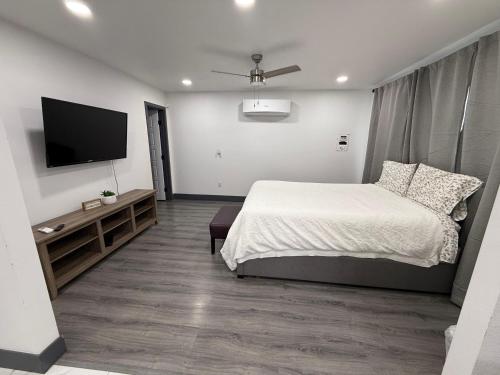 a bedroom with a bed and a flat screen tv at Cozy Guest House in amazing Las Vegas in Las Vegas