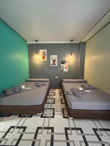 a room with two beds in a room at Baybay Hostel in Siquijor