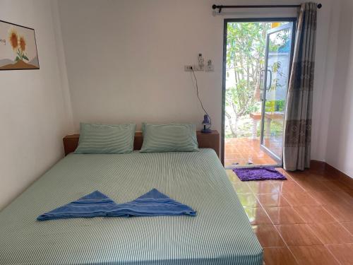 a bedroom with a bed with blue sheets on it at Lonely Beach Pool Resort in Ko Chang