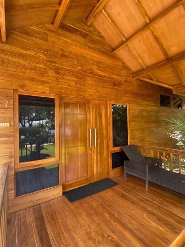 a large room with wooden walls and wooden flooring at Han's Villa in Sumbawa Besar