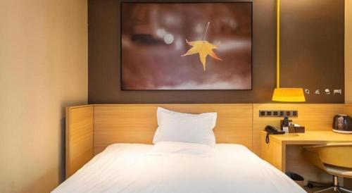 a bedroom with a bed with a star on the wall at IU Hotel Kunming Jinma Bijifang Joy City in Kunming