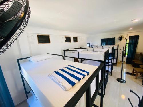 a row of beds in a row in a room at Ella Mount Hostel in Ella