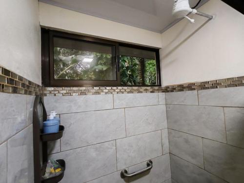 a bathroom with a shower with a window at Villas Los Titos in La Fortuna in San Francisco