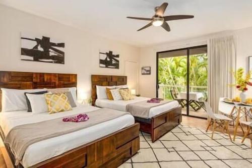 a bedroom with two beds and a ceiling fan at Premier Collection at Grand Champions Wailea - Limited-Time Half Off in Wailea