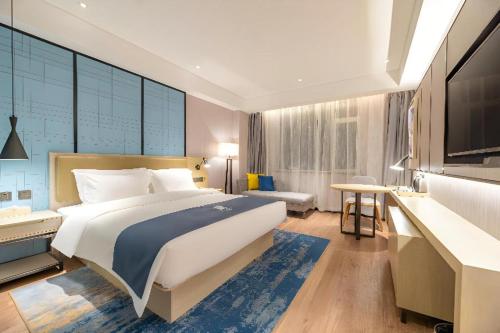 Postel nebo postele na pokoji v ubytování Echarm Hotel Tai'an Taishan Tianwai Village Hongmen