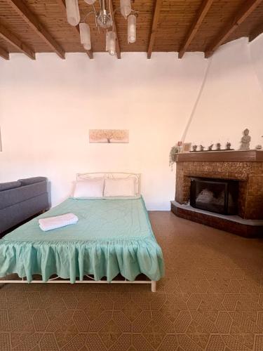 a bed in a room with a fireplace at Aμvrosia Avramio Village - Fireplace, Free WiFi, Pet Friendly in Avramión