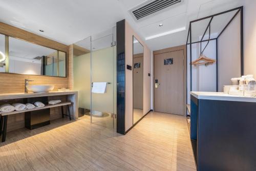 a bathroom with a sink and a mirror at Atour X Hotel Shenzhen Luohu Dongmen Pedestrian Street in Shenzhen
