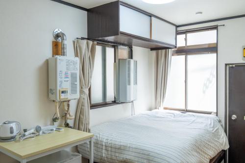 a hospital room with a bed and a window at Kanamachi INN A-1 in Tokyo