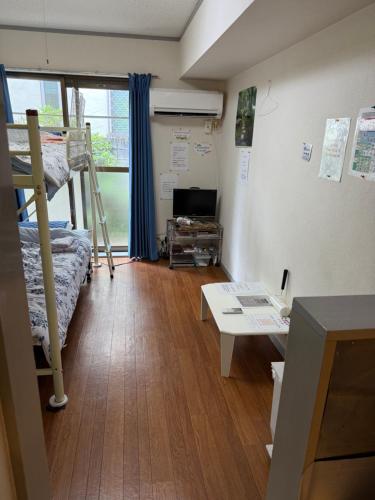 a room with a bunk bed and a desk at 17 minutes from Shinjuku, room 108 in Tokyo