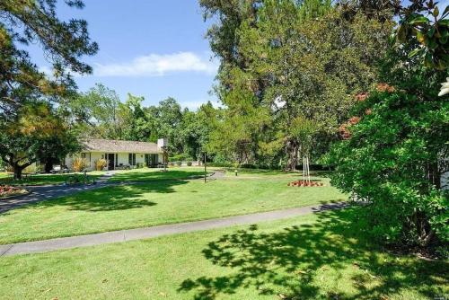 a park with a house and trees and a path at The Napa Residences in Napa