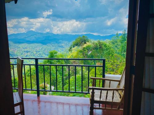 a balcony with a view of the mountains at Okeed Ella in Ella
