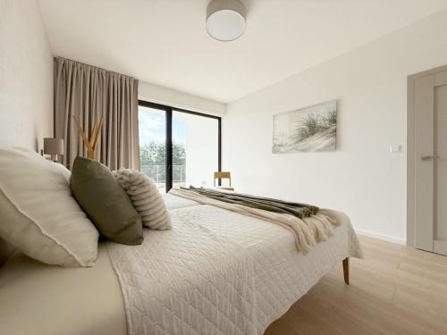 Ένα ή περισσότερα κρεβάτια σε δωμάτιο στο Luxapartment 101 Golf & Lake Penati