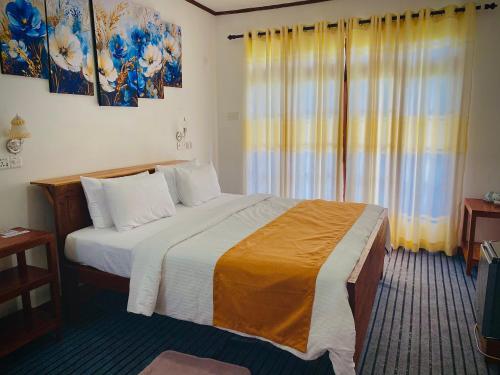 a bedroom with a large bed and a window at Okeed Ella in Ella