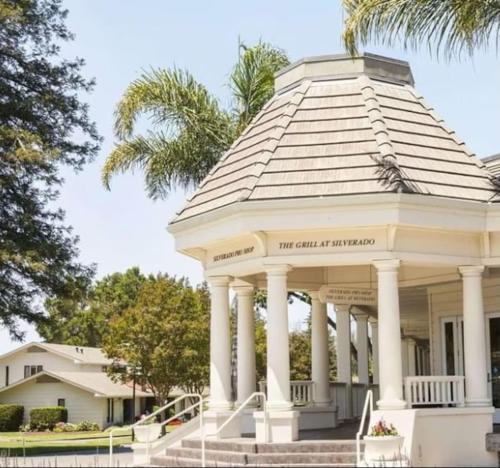 a gazebo in front of a house with palm trees at The Napa Residences in Napa