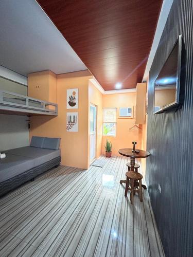 a small room with a bed and a table at Baybay Hostel in Siquijor
