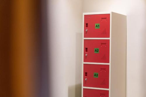 a shelf with red and green boxes at Pondok Tis Bisma in Ubud