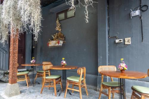 a group of tables and chairs in a restaurant at Pondok Tis Bisma in Ubud