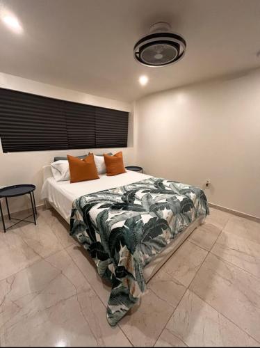 a bedroom with a large bed with orange pillows at MIAMI ROOMs in Miami