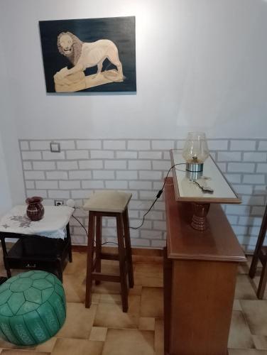 a room with two tables and a painting on the wall at Άνετη και δροσερή κατοικία in Taxiárkhai