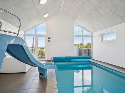 a swimming pool with a slide in a house at 5 star holiday home in Glesborg in Glesborg