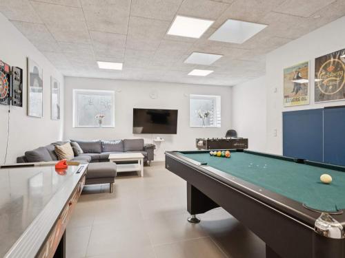 a living room with a pool table and a couch at 5 star holiday home in Glesborg in Glesborg