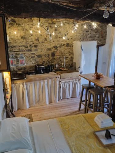 a kitchen with white curtains and a table in a room at Pace attraverso gli occhi in Perledo