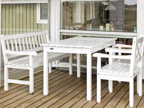 a white table and two chairs on a porch at 7 person holiday home in Fanø-By Traum in Fanø