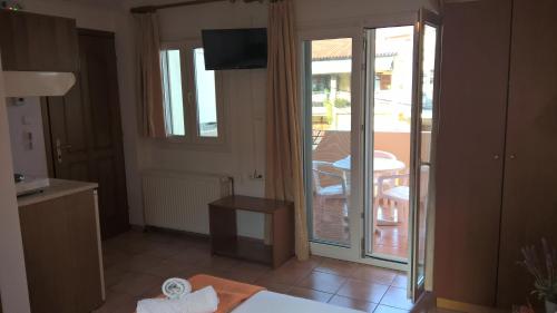 a kitchen with a door open to a balcony at Muses in Neos Marmaras