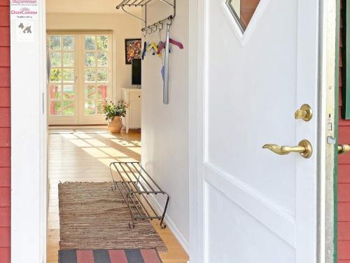 a hallway with a white door and a rug at 4 person holiday home in SÖLVESBORG-By Traum in Björkenäs