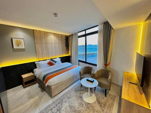 a hotel room with a bed and a television at Diamond Palm Hotel & Resort in Al Burj