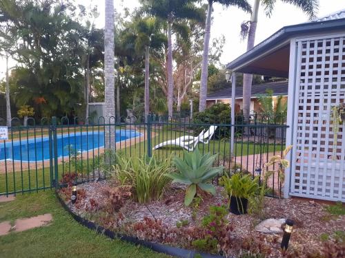 a fence in front of a swimming pool at Cleveland Motor Inn in Cleveland
