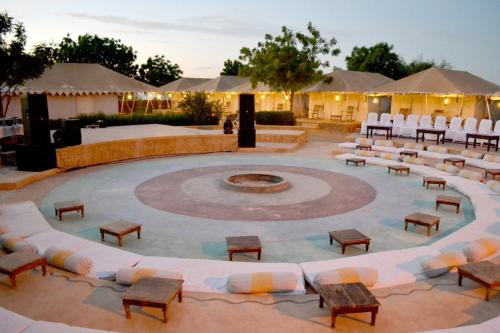 a large amphitheater with chairs and a fire pit at The Desert Resort Jaisalmer in Jaisalmer