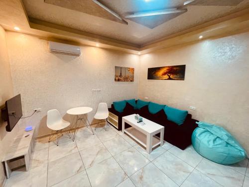 a living room with a couch and a table at Luxury Apartment with jacuzzi on Republic Square in Yerevan