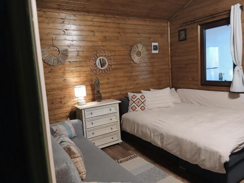 a bedroom with a bed and a dresser and a window at Popa Cabana in Sibiu