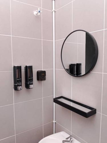 a bathroom with a mirror and a toilet at Nazana Homestay in Batu Gajah