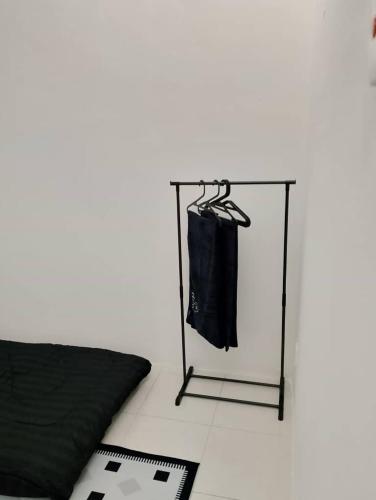 a room with a glass table with a towel rack at Nazana Homestay in Batu Gajah