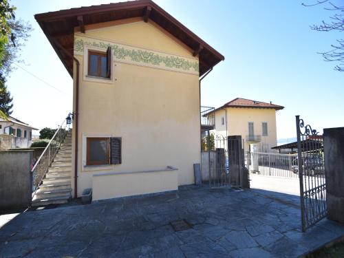 a house with a gate and a staircase leading up to it at Spacious Retreat in Cannero in Cannero Riviera