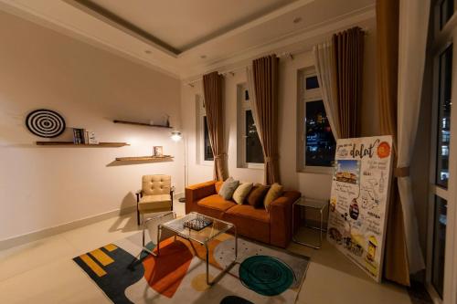 a living room with a couch and a table at Mây Hoa Tiên Villa - House in Da Lat