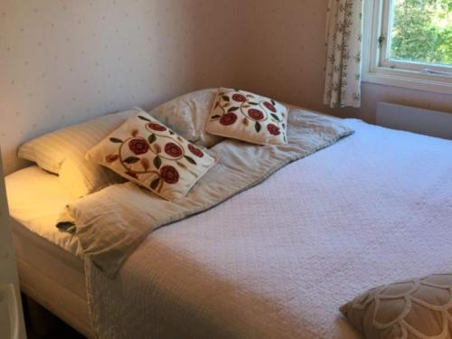 a bed with pillows on it in a bedroom at 5 person holiday home in TYRESÖ in Tyresö